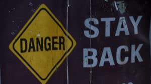 Danger stay back sign to keep people away from hitting toddler